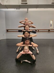 Character dancers enjoy a moment of levity.